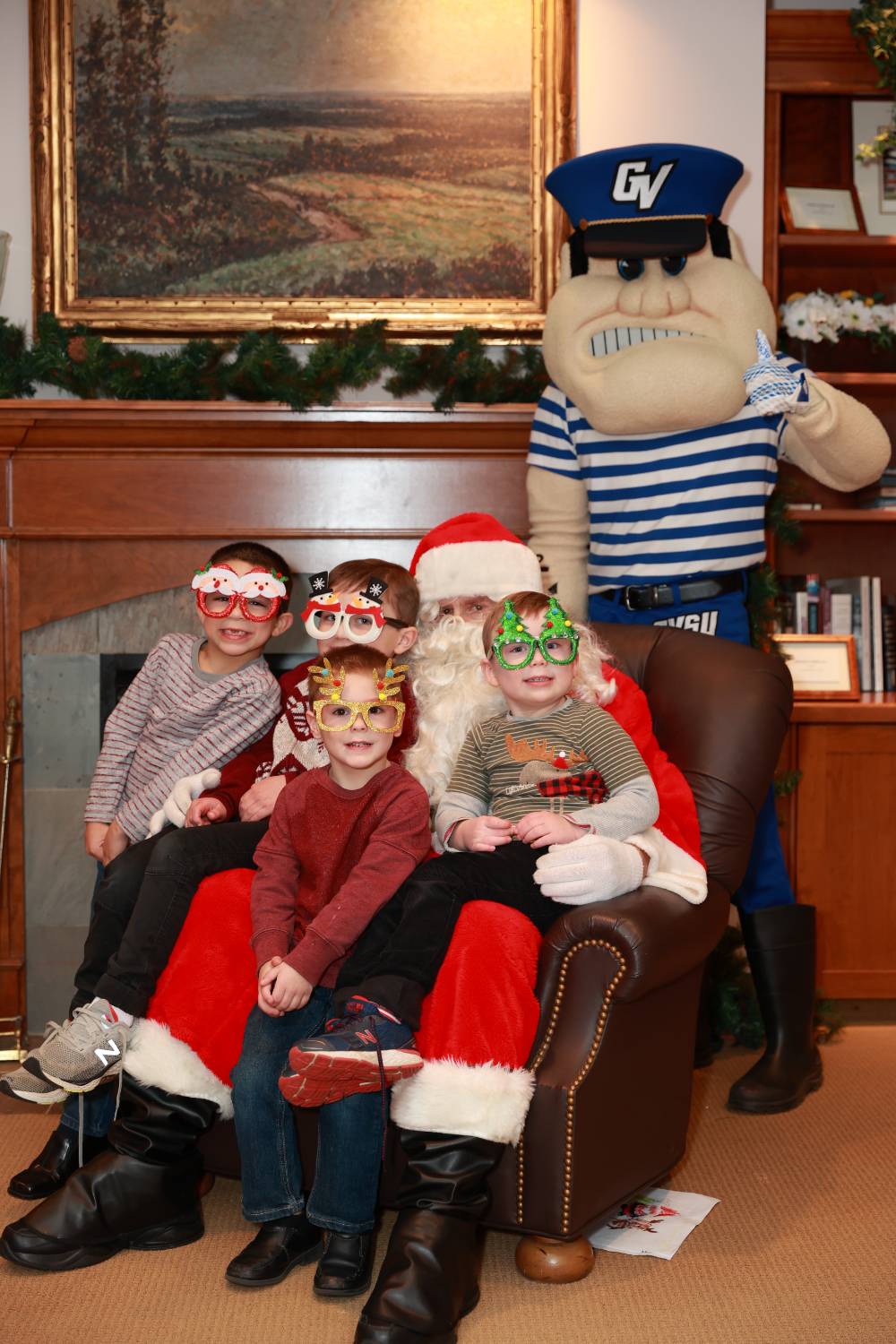 Four brothers sitting with Santa & Louie.